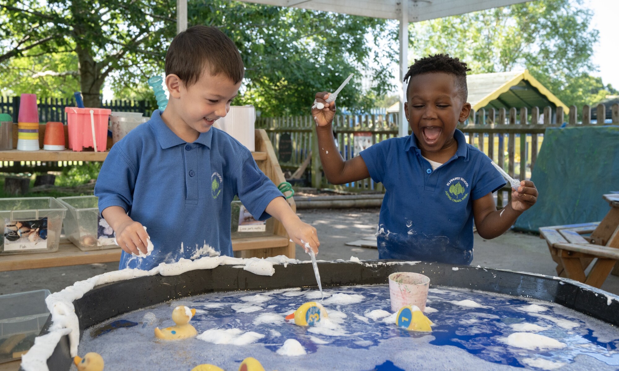 Elmhurst school boys playing with water and toys