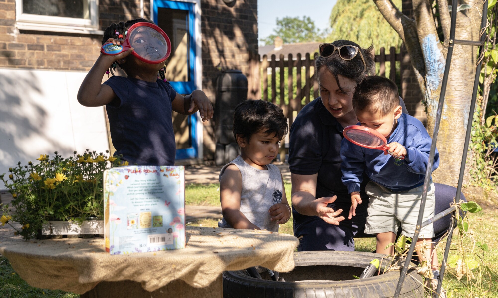 Elmhurst school exploring with magnifying glasses outdoors
