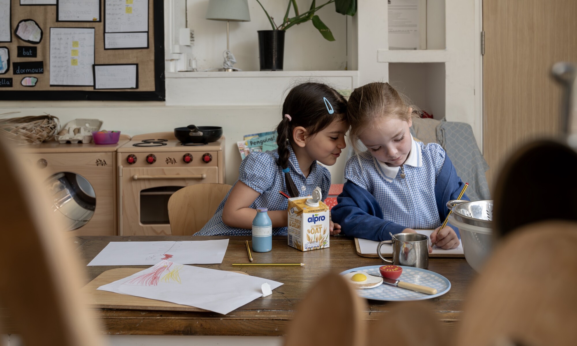 Elmhurst school girls engaged in creative play at a table