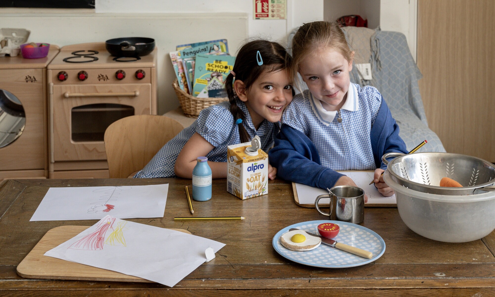 Elmhurst school two girls smiling while working on an activity